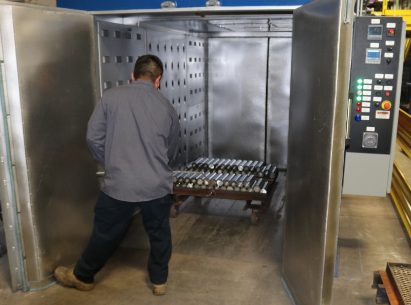 Unloading parts that have been industrial chrome plated, from an industrial oven.